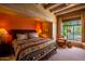 Cozy bedroom with wooden beams, comfortable seating, and large windows with outdoor view at 8502 E Cave Creek Rd # 61, Carefree, AZ 85377