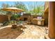 Outdoor entertaining area with built-in grill, fireplace, and shaded seating area at 8502 E Cave Creek Rd # 61, Carefree, AZ 85377