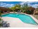 Sparkling pool with a tanning ledge, water feature, and lounge chairs, surrounded by lush landscaping and desert flora at 8502 E Cave Creek Rd # 61, Carefree, AZ 85377