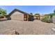 Expansive gravel backyard with a patio area perfect for outdoor entertaining at 9226 W Topeka Dr, Peoria, AZ 85382