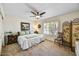 Comfortable bedroom with plush carpeting, ceiling fan, and bright window at 9226 W Topeka Dr, Peoria, AZ 85382