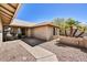 Inviting front entry of a single-story home featuring a concrete walkway and desert landscaping at 9226 W Topeka Dr, Peoria, AZ 85382