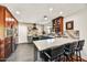 Modern kitchen with stainless steel appliances, dark gray cabinets, and a light countertop with breakfast bar and stools at 9226 W Topeka Dr, Peoria, AZ 85382
