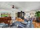 Open-concept living area featuring hardwood floors, a ceiling fan, and ample seating at 9226 W Topeka Dr, Peoria, AZ 85382