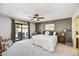 Spacious main bedroom with a ceiling fan and sliding glass door at 9226 W Topeka Dr, Peoria, AZ 85382