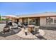 Backyard featuring comfortable seating, an umbrella, an outdoor kitchen, and desert landscaping at 9226 W Topeka Dr, Peoria, AZ 85382