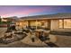Backyard showcasing comfortable seating, an umbrella, and an outdoor dining area at 9226 W Topeka Dr, Peoria, AZ 85382