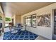 Covered patio featuring a bistro table, decorative rug, and modern accents at 9226 W Topeka Dr, Peoria, AZ 85382