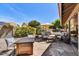 Inviting outdoor living space with a gas fire pit, comfortable seating, and vibrant greenery at 9226 W Topeka Dr, Peoria, AZ 85382