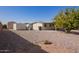 A compact, low-maintenance backyard offering a peaceful retreat with gravel landscaping and mature shade tree at 931 S 91St Pl, Mesa, AZ 85208