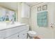 Bright bathroom featuring a white vanity with sink and a decorative mirror at 931 S 91St Pl, Mesa, AZ 85208