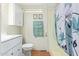 Bathroom with white vanity, bathtub with shower, and patterned wallpaper at 931 S 91St Pl, Mesa, AZ 85208