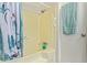 Bathroom showcases a bathtub with shower with blue floral shower curtain at 931 S 91St Pl, Mesa, AZ 85208