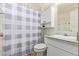 Bathroom featuring a white vanity, toilet, and shower with patterned curtain at 931 S 91St Pl, Mesa, AZ 85208