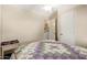 View of bedroom showing bed and glimpse into adjacent laundry area at 931 S 91St Pl, Mesa, AZ 85208