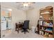 Bedroom featuring neutral walls, ceiling fan, a desk, and an open laundry room at 931 S 91St Pl, Mesa, AZ 85208