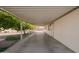Extra-long carport featuring mature orange trees and an entrance to the home at 931 S 91St Pl, Mesa, AZ 85208