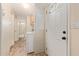 Hallway view of a bright interior leading to bathroom with washer/dryer hookups next to the home's entry door at 931 S 91St Pl, Mesa, AZ 85208