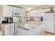 Bright kitchen with white cabinetry, essential appliances, and functional center island at 931 S 91St Pl, Mesa, AZ 85208