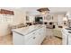 Modern kitchen island with stone countertops offering additional workspace and seating at 931 S 91St Pl, Mesa, AZ 85208