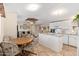 Open-concept kitchen with white cabinets, center island, and adjacent dining area at 931 S 91St Pl, Mesa, AZ 85208