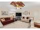 Comfortable living room with ceiling fan, large screen television, and abundant seating at 931 S 91St Pl, Mesa, AZ 85208