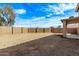 Large backyard enclosed by a block wall, offering privacy and potential for customization at 11501 N Pablo St, El Mirage, AZ 85335