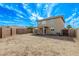 Backyard view showcasing the home's exterior and the expansive, walled yard at 11501 N Pablo St, El Mirage, AZ 85335