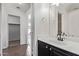 Well-lit bathroom featuring a black vanity, white countertop, and a view into the walk-in closet at 11501 N Pablo St, El Mirage, AZ 85335
