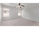 Bright, empty bedroom with carpet, ceiling fan, and many windows at 11501 N Pablo St, El Mirage, AZ 85335