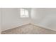 Bright bedroom with a large window, carpet flooring, and blank canvas aesthetic, ready for personalization at 11501 N Pablo St, El Mirage, AZ 85335