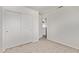 Simple bedroom featuring carpet flooring, a double door closet, and ample natural light at 11501 N Pablo St, El Mirage, AZ 85335