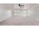 Bright bonus room with carpet flooring and large windows offering pleasant desert views at 11501 N Pablo St, El Mirage, AZ 85335