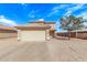 Front exterior of a home with a two-car garage, desert landscaping, and a red tile roof on a sunny day at 11501 N Pablo St, El Mirage, AZ 85335