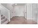 Bright foyer featuring neutral tile flooring, white walls, a staircase, and two entry doors at 11501 N Pablo St, El Mirage, AZ 85335