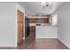 An empty kitchen features stainless appliances, light countertops and a breakfast bar at 11501 N Pablo St, El Mirage, AZ 85335