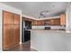 The kitchen features wood cabinets, stainless appliances and a breakfast bar at 11501 N Pablo St, El Mirage, AZ 85335