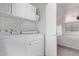 Functional laundry room with overhead storage, a washer, and a dryer at 11501 N Pablo St, El Mirage, AZ 85335
