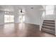 Spacious living room with large windows, tiled floors, staircase, and sliding glass doors to the backyard at 11501 N Pablo St, El Mirage, AZ 85335