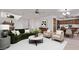 Inviting living room with stylish furniture, neutral tones, and an open layout connecting to the kitchen at 11501 N Pablo St, El Mirage, AZ 85335