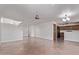 Open living area featuring tiled floors, a staircase, and a view into the kitchen with dark wood cabinets at 11501 N Pablo St, El Mirage, AZ 85335