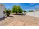 Wide-open backyard with trees, minimalist landscaping, and block wall fencing for privacy at 13238 N 78Th St, Scottsdale, AZ 85260