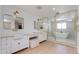 Luxurious bathroom boasting dual vanities, a soaking tub, and a glass-enclosed shower for a spa-like experience at 13238 N 78Th St, Scottsdale, AZ 85260