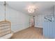 Spacious bedroom with a hanging chair, light hardwood floors, and vibrant wallpaper at 13238 N 78Th St, Scottsdale, AZ 85260
