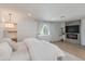 Inviting bedroom featuring a fireplace, wood floors, and natural light at 13238 N 78Th St, Scottsdale, AZ 85260