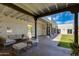 Spacious covered patio area with comfortable seating, offering a great view of the backyard and pool at 13238 N 78Th St, Scottsdale, AZ 85260