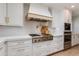 Well-equipped kitchen with stainless steel appliances, custom cabinetry, and a modern range hood for culinary enthusiasts at 13238 N 78Th St, Scottsdale, AZ 85260