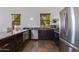 Well-appointed kitchenette featuring stainless steel appliances, dark wood cabinetry, and natural lighting at 13238 N 78Th St, Scottsdale, AZ 85260