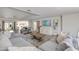 Spacious living room with a comfortable sofa, modern decor, and an open layout leading to the dining area and kitchen at 13238 N 78Th St, Scottsdale, AZ 85260