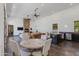 Expansive living room with an open floor plan, stone fireplace, and views from the dining table at 13238 N 78Th St, Scottsdale, AZ 85260
